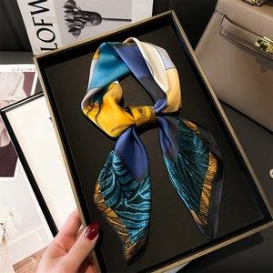 Silk-textured square scarf with geometric patterns in a black gift presentation box