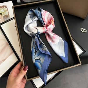 Detailed view of elegant peony print silk scarf with floral patterns in blue and pink