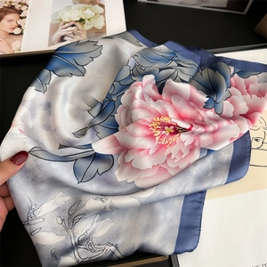 Close-up of pink peony and blue leaf print on glossy silk-like square scarf