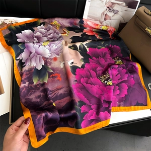 Detail of silk-like square scarf with peony floral print and orange border detail