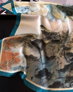 Close-up of landscape ink painting pattern and satin texture on a silk scarf