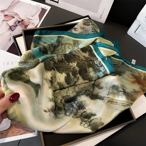 Close-up of silk-feel square scarf featuring traditional green landscape ink painting