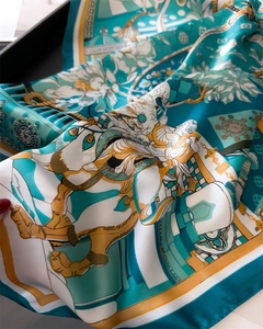 Detail of silk satin scarf with green mythological figures and classical floral patterns