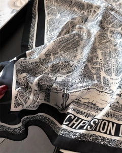 Detail shot of black and white vintage map print silk scarf with satin finish and luster