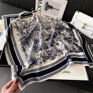 Close-up of Toile de Jouy silk square scarf with blue landscape print and smooth texture