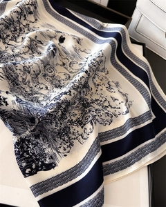 Detail of French Toile de Jouy pattern blue and white silk square scarf tied on a handbag