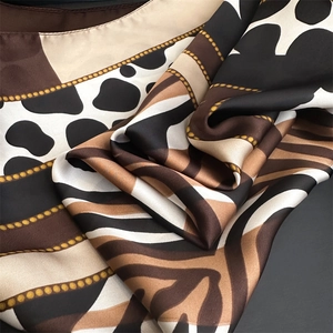 Detailed view of the leopard and chain print satin scarf with premium silky texture