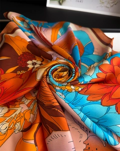 Detailed macro view of sunflower silk scarf featuring vintage floral print and satin texture