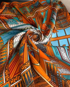 Detailed close-up of colorful silk scarf featuring intricate European architecture prints