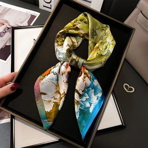 Detail of colorful geometric floral silk scarf styled with luxury fashion accessories