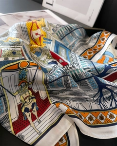 Close-up of silk square scarf featuring intricate classical horse and bee illustrations