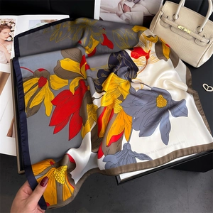 Elegant floral silk square scarf with artistic print and navy blue rolled edges