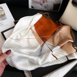 Elegant geometric print silk scarf with caramel and coffee tones in a chic setting