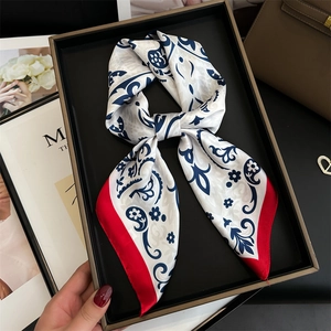 Elegant vintage silk scarf with red borders and blue paisley pattern on ivory base