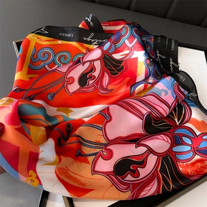 Detail of colorful floral silk scarf with black satin edges and artistic typography