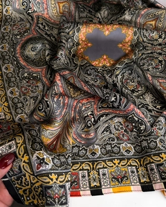 Close-up of silky paisley pattern scarf with detailed ethnic print and satin texture