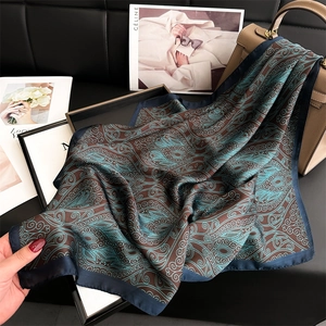 Luxurious paisley silk scarf with vintage ethnic patterns on a stylish leather background