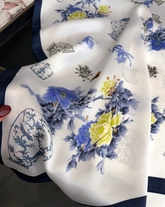 Close-up of lightweight blue and white porcelain style silk scarf with floral pattern