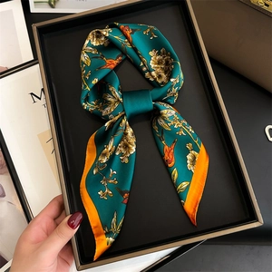 Peacock green silk scarf with birds and flowers in a black luxury gift box