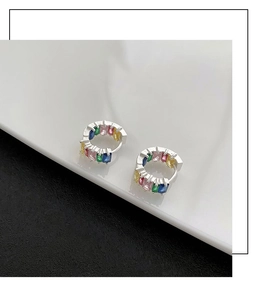 Macro view of rainbow gemstone earrings with rectangular cut crystals in silver setting
