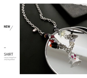 Detail view of ghostly pendant with colorful stone chips on silver chain jewelry