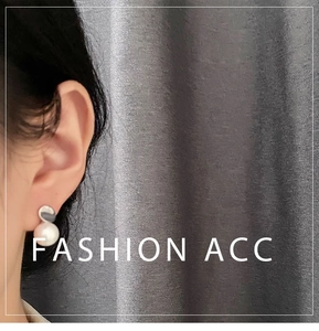 Detail of 925 silver pearl stud earring with irregular metal piece on a model's ear