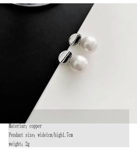 Detail view of 1.7cm faux pearl earrings with copper base and silver dome finish