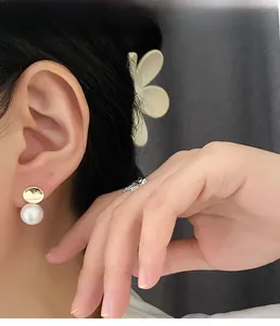 Elegant 925 silver pearl stud earrings featuring gold metallic details and soft luster