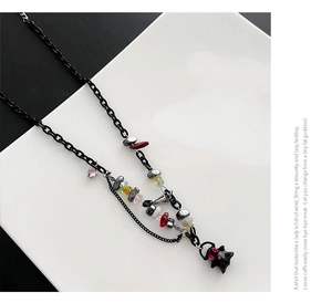Detail of hip-hop necklace with black ghost pendant and colorful gravel stone splicing
