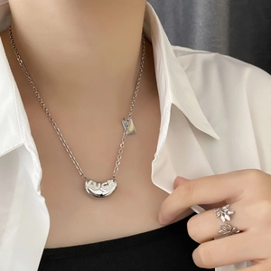 S925 silver luck bean necklace and leaf ring set on model with white shirt