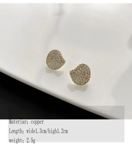 Macro detail of irregular gold copper stud earrings with shimmering zircon micro-pave