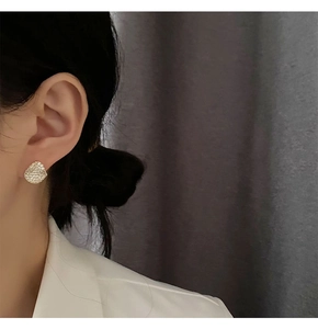 Close-up of S925 silver stud earring with pavé diamonds on a model's ear
