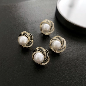 Elegant floral pearl stud earrings in black and gold finish with shimmering crystals
