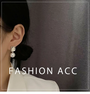 Detail of square silver metal stud with a round pearl earring on a model