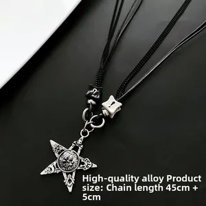 Macro shot of gothic silver star pendant with skull symbols and black cord chain