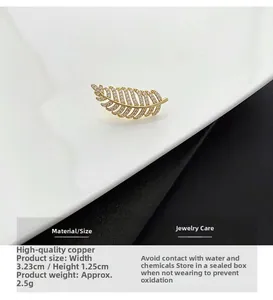 Close-up of zircon leaf brooch in gold copper with 3.23cm width and 1.25cm height