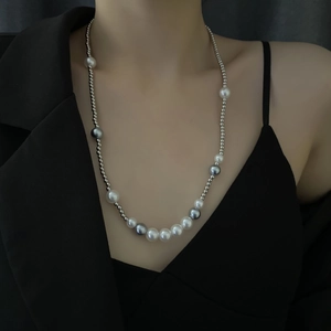 Unisex pearl necklace with silver metal beads and grey accents on a black blazer