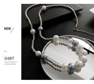 Detail of silver bead chain with white and grey pearls showing lobster clasp and extension