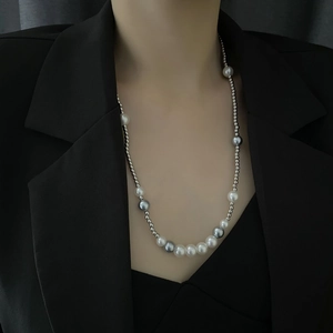 Long pearl necklace for men with white grey and silver beads on black blazer suit