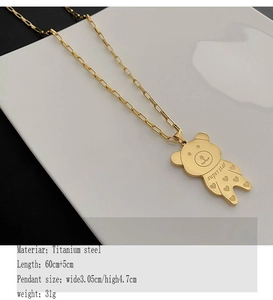 Detail of titanium steel bear pendant with super star engraving on long necklace