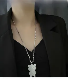Detail of silver bear pendant with superstar engraving on titanium steel long chain