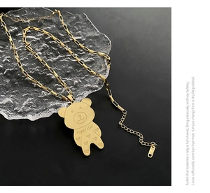 Macro detail of golden bear pendant with super star engraving and heart patterns