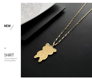 Macro detail of golden bear pendant with Super Star engraving on a square link chain