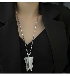 Detail of bear pendant with super star engraving on long stainless steel box chain