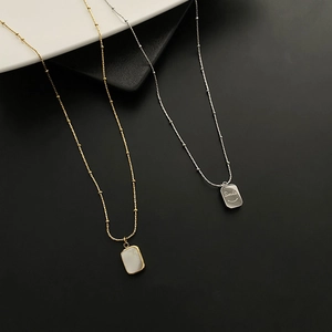 Minimalist double-sided shell smile pendant necklace with beaded gold and silver chains