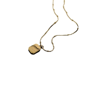 Golden rectangle pendant necklace with Smile engraving and shell smiley face detail