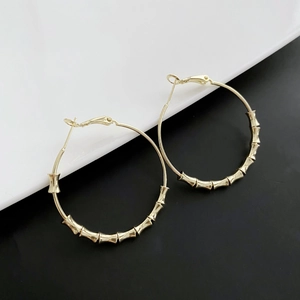 Minimalist gold bamboo joint hoop earrings for women with polished metal finish