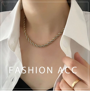 Close-up of twisted two-tone gold and silver rope chain necklace worn by a model