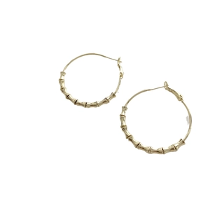 Chic gold bamboo texture large hoop earrings with minimalist high-end luxury design