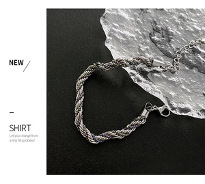 Macro view of silver twisted braid bracelet with colorful accents and lobster clasp
